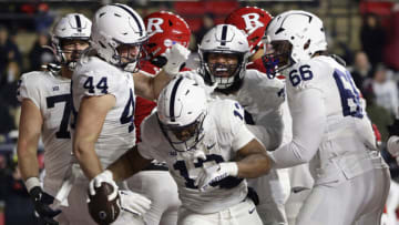 PISCATAWAY, NJ - NOVEMBER 19: Running back Kaytron Allen #13 of the Penn State Nittany Lions is congratulated by teammates Tyler Warren #44, Juice Scruggs #70 and Drew Shelton #66 after scoring a touchdown on an eight-yard run during the third quarter of a game against the Rutgers Scarlet Knights at SHI Stadium on November 19, 2022 in Piscataway, New Jersey. Penn State defeated Rutgers 55-10. (Photo by Rich Schultz/Getty Images)