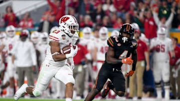 MIAMI GARDENS, FL - DECEMBER 30: Jonathan Taylor #23 of the Wisconsin Badgers carries during the first quarter of the 2017 Capital One Orange Bowl against the Miami Hurricanes at Hard Rock Stadium on December 30, 2017 in Miami Gardens, Florida. (Photo by Rob Foldy/Getty Images)