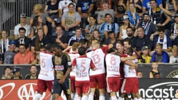 Aug 1, 2015; Philadelphia, PA, USA; Philadelphia Union defender Raymon Gaddis (28) walks past New York Red Bulls as they celebrate a goal during the second half at PPL Park. The Red Bulls won 3-1. Mandatory Credit: Eric Hartline-USA TODAY Sports