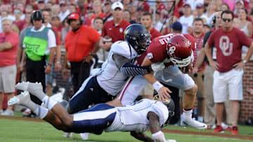 Sep 5, 2015; Norman, OK, USA; Oklahoma Sooners quarterback Baker Mayfield (6) is tackled by Akron Zips linebacker Jatavis Brown (1) and Zips defensive back Larry Hope (2) during the second quarter at Gaylord Family - Oklahoma Memorial Stadium. Mandatory Credit: Mark D. Smith-USA TODAY Sports