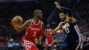 HOUSTON, TX - NOVEMBER 22: Chris Paul #3 of the Houston Rockets dribbles around Jamal Murray #27 of the Denver Nuggets in the second quarter at Toyota Center on November 22, 2017 in Houston, Texas. NOTE TO USER: User expressly acknowledges and agrees that, by downloading and or using this photograph, User is consenting to the terms and conditions of the Getty Images License Agreement. (Photo by Bob Levey/Getty Images)