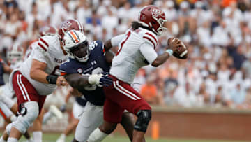 Auburn footballSep 2, 2023; Auburn, Alabama, USA; Auburn Tigers defensive lineman Jayson Jones (99) tackles Massachusetts Minutemen quarterback Taisun Phommachanh (3) during the third quarter at Jordan-Hare Stadium. Mandatory Credit: John Reed-USA TODAY Sports