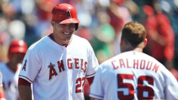July 26, 2015; Anaheim, CA, USA; Los Angeles Angels right fielder Kole Calhoun (56) congratulates center fielder Mike Trout (27) after hitting a grand slam home run in the sixth inning against the Texas Rangers at Angel Stadium of Anaheim. Mandatory Credit: Gary A. Vasquez-USA TODAY Sports