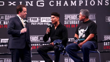 Kenny Albert, Mikey Garcia and Robert Garcia speak onstage. (Photo by Joe Scarnici/Getty Images)