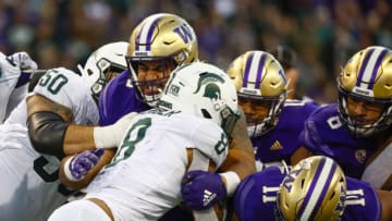Sep 17, 2022; Seattle, Washington, USA; Washington Huskies defensive lineman Voi Tunuufi (90) tackles Michigan State Spartans running back Jalen Berger (8) during the third quarter at Alaska Airlines Field at Husky Stadium. Mandatory Credit: Joe Nicholson-USA TODAY Sports