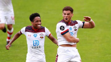 BOURNEMOUTH, ENGLAND - JULY 19: Che Adams of Southampton celebrates with Kyle Walker-Peters of Southampton after scoring his sides second goal during the Premier League match between AFC Bournemouth and Southampton FC at Vitality Stadium on July 19, 2020 in Bournemouth, England. Football Stadiums around Europe remain empty due to the Coronavirus Pandemic as Government social distancing laws prohibit fans inside venues resulting in all fixtures being played behind closed doors. (Photo by Ian Walton/Pool via Getty Images)