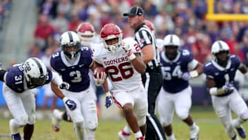 FORT WORTH, TX - OCTOBER 20: Kennedy Brooks #26 of the Oklahoma Sooners carries the ball against the TCU Horned Frogs defense in the first half at Amon G. Carter Stadium on October 20, 2018 in Fort Worth, Texas. (Photo by Tom Pennington/Getty Images)