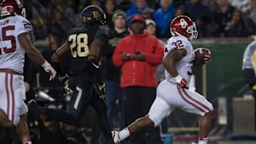 Nov 14, 2015; Waco, TX, USA; Oklahoma Sooners running back Samaje Perine (32) stiff arms Baylor Bears safety Orion Stewart (28) and scores a touchdown during the second half at McLane Stadium. Mandatory Credit: Jerome Miron-USA TODAY Sports
