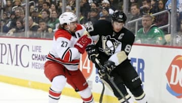 Jan 17, 2016; Pittsburgh, PA, USA; Carolina Hurricanes defenseman Justin Faulk (27) checks Pittsburgh Penguins center Sidney Crosby (87) off of the puck during the first period at the CONSOL Energy Center. Mandatory Credit: Charles LeClaire-USA TODAY Sports