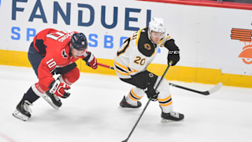 May 17, 2021; Washington, District of Columbia, USA; Boston Bruins center Curtis Lazar (20) passes the puck away from Washington Capitals right wing Daniel Sprong (10) during the first period in game two of the first round of the 2021 Stanley Cup Playoffs at Capital One Arena. Mandatory Credit: Brad Mills-USA TODAY Sports