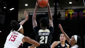 BOULDER, COLORADO - FEBRUARY 16: Mya Hollingshed #21 of the Colorado Buffaloes looks for open teammates past the defense of Maya Dodson #15 and Kiana Williams #23 of the Stanford Cardinal during the fourth quarter of a game between the Stanford Cardinal and the Colorado Buffaloes at Coors Events Center on February 16, 2020 in Boulder, Colorado. The Cardinal defeated the Buffaloes 69-66 with a buzzer beating-half court shot from Kiana Williams #23 of the Stanford Cardinal. (Photo by Lizzy Barrett/Getty Images)