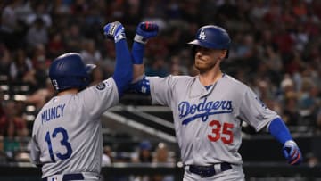 PHOENIX, ARIZONA - JUNE 26: Cody Bellinger #35 of the Los Angeles Dodgers celebrates with Max Muncy #13 after hitting a solo home run off of Taylor Clarke #45 of the Arizona Diamondbacks during the fourth inning at Chase Field on June 26, 2019 in Phoenix, Arizona. (Photo by Norm Hall/Getty Images)