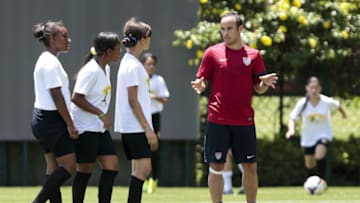 Player Landon Donovan, of the US national football team, talks to young girls during a session of the Sport for All, an initiative between the US and Brazil aimed at reaching marginalized audiences and promoting social inclusion, at the Sao Paulo FC training centre in Sao Paulo, on January 22, 2014. The team arrived in Sao Paulo last week for a 12-day training session as part of their "dry run" for the upcoming Brazil 2014 FIFA World Cup. AFP PHOTO / Miguel SCHINCARIOL (Photo credit should read Miguel Schincariol/AFP via Getty Images)
