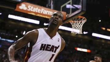 Mar 31, 2014; Miami, FL, USA; Miami Heat center Chris Bosh (1) reacts after a dunk against the Toronto Raptors in the second half at American Airlines Arena. The Heat won 93-83. Mandatory Credit: Robert Mayer-USA TODAY Sports