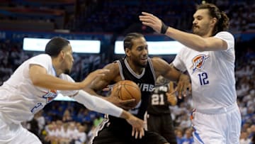May 6, 2016; Oklahoma City, OK, USA; San Antonio Spurs forward Kawhi Leonard (2) drives to the basket between Oklahoma City Thunder guard Andre Roberson (21) and center Steven Adams (12) during the fourth quarter in game three of the second round of the NBA Playoffs at Chesapeake Energy Arena. Mandatory Credit: Mark D. Smith-USA TODAY Sports