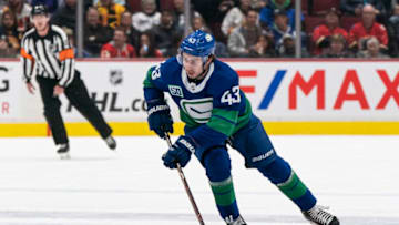 VANCOUVER, BC - FEBRUARY 08: Quinn Hughes #43 of the Vancouver Canucks skates with the puck in NHL action against the Calgary Flames at Rogers Arena on February 8, 2020 in Vancouver, Canada. (Photo by Rich Lam/Getty Images)
