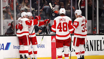 ANAHEIM, CALIFORNIA - NOVEMBER 12: Dylan Larkin #71, Anthony Mantha #39, and Givani Smith #48 congratulate Dennis Cholowski #21 of the Detroit Red Wings after his goal in overtime of a game against the Anaheim Ducks at Honda Center on November 12, 2019 in Anaheim, California. The Detroit Red Wings defeated the Anaheim Ducks 4-3. (Photo by Sean M. Haffey/Getty Images)