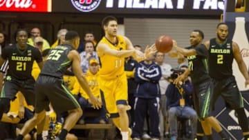 Feb 6, 2016; Morgantown, WV, USA; West Virginia Mountaineers forward Nathan Adrian (11) passes out during the first half against the Baylor Bears at the WVU Coliseum. Mandatory Credit: Ben Queen-USA TODAY Sports