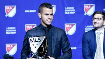 Dec 2, 2015; Toronto, Ontario, Canada; Toronto FC midfielder Sebastian Giovinco holds the Landon Donovan MVP trophy after being named 2015 most valuable player by Major League Soccer during a presentation at Air Canada Centre. Looking on at right is Toronto FC general manager Tim Bezbatchenko. Mandatory Credit: Dan Hamilton-USA TODAY Sports