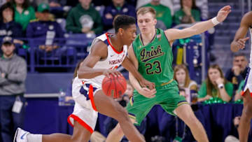 SOUTH BEND, IN - JANUARY 26: De'Andre Hunter #12 of the Virginia Cavaliers dribbles the ball against Dane Goodwin #23 of the Notre Dame Fighting Irish at Purcell Pavilion on January 26, 2019 in South Bend, Indiana. (Photo by Michael Hickey/Getty Images)