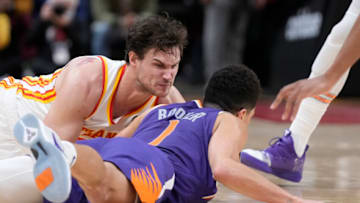 Feb 3, 2022; Atlanta, Georgia, USA; Atlanta Hawks forward Danilo Gallinari (8) (left) and Phoenix Suns guard Devin Booker (1) dive for a loose ball during the second half at State Farm Arena. Mandatory Credit: Dale Zanine-USA TODAY Sports