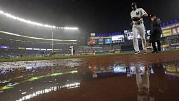 Sep 30, 2016; Bronx, NY, USA; New York Yankees right fielder Aaron Hicks (31) heads for the dugout in the rain during the fourth inning against the Baltimore Orioles at Yankee Stadium. Mandatory Credit: Adam Hunger-USA TODAY Sports