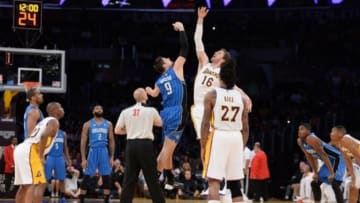 Mar 23, 2014; Los Angeles, CA, USA; Orlando Magic forward Nikola Vucevic (9) battles for the tip-off with Los Angeles Lakers forward Pau Gasol (16) in the first quarter at Staples Center. Mandatory Credit: Kirby Lee-USA TODAY Sports