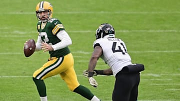 GREEN BAY, WISCONSIN - NOVEMBER 15: Aaron Rodgers #12 of the Green Bay Packers looks for a receiver under pressure from Josh Allen #41 of the Jacksonville Jaguars at Lambeau Field on November 15, 2020 in Green Bay, Wisconsin. (Photo by Stacy Revere/Getty Images)