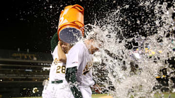 OAKLAND, CALIFORNIA - JUNE 20: Matt Chapman #26 of the Oakland Athletics is dumped with water by Matt Olson #28 after Chapman hit a walk-off home run to beat the Tampa Bay Rays at Ring Central Coliseum on June 20, 2019 in Oakland, California. (Photo by Ezra Shaw/Getty Images)
