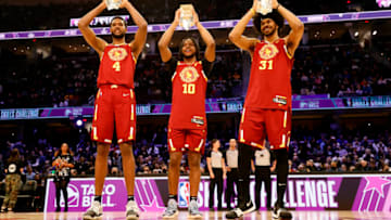 CLEVELAND, OHIO - FEBRUARY 19: Evan Mobley #4, Darius Garland #10 and Jarrett Allen #31 of Team Cavs hold up their trophies after winning the Taco Bell Skills Challenge as part of the 2022 NBA All Star Weekend at Rocket Mortgage Fieldhouse on February 19, 2022 in Cleveland, Ohio. NOTE TO USER: User expressly acknowledges and agrees that, by downloading and or using this photograph, User is consenting to the terms and conditions of the Getty Images License Agreement. (Photo by Tim Nwachukwu/Getty Images)