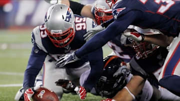 Nov 24, 2013; Foxborough, MA, USA; New England Patriots defensive end Chandler Jones (95) recovers a fumble during the third quarter against the Denver Broncos at Gillette Stadium. Mandatory Credit: Stew Milne-USA TODAY Sports