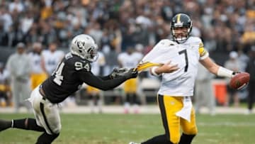 Oct 27, 2013; Oakland, CA, USA; Pittsburgh Steelers quarterback Ben Roethlisberger (7) attempts to escape from the grasp of Oakland Raiders outside linebacker Kevin Burnett (94) during the fourth quarter at O.co Coliseum. The Oakland Raiders defeated the Pittsburgh Steelers 21-18. Mandatory Credit: Ed Szczepanski-USA TODAY Sports