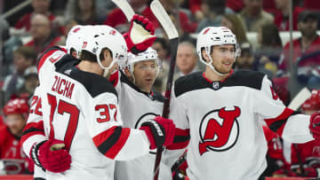 Apr 4, 2019; Raleigh, NC, USA; New Jersey Devils defenseman Andy Greene (6) celebrates his first period goal with center Pavel Zacha (37) and center Michael McLeod (41) against the Carolina Hurricanes at PNC Arena. Mandatory Credit: James Guillory-USA TODAY Sports