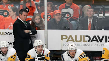 PHILADELPHIA, PA - APRIL 18: Head Coach of the Pittsburgh Penguins Mike Sullivan looks on during the first period behind Bryan Rust #17, Conor Sheary #43 and Carl Hagelin #62 against the Philadelphia Flyers in Game Four of the Eastern Conference First Round during the 2018 NHL Stanley Cup Playoffs at the Wells Fargo Center on April 18, 2018 in Philadelphia, Pennsylvania. (Photo by Len Redkoles/NHLI via Getty Images)