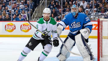 WINNIPEG, MB - MARCH 25: Blake Comeau #15 of the Dallas Stars and goaltender Connor Hellebuyck #37 of the Winnipeg Jets keep an eye on the play during first period action at the Bell MTS Place on March 25, 2019 in Winnipeg, Manitoba, Canada. (Photo by Jonathan Kozub/NHLI via Getty Images)