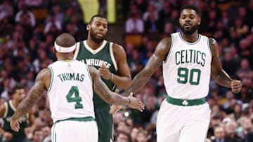 Feb 25, 2016; Boston, MA, USA; Boston Celtics guard Isaiah Thomas (4) and forward Amir Johnson (90) celebrate against the Milwaukee Bucks during the first half at TD Garden. Mandatory Credit: Mark L. Baer-USA TODAY Sports