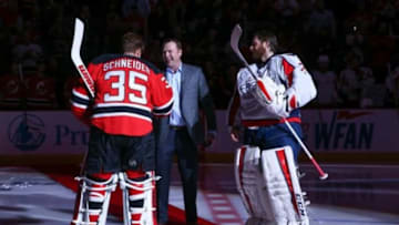 Feb 6, 2016; Newark, NJ, USA; Former New Jersey Devils goaltender Martin Brodeur drops the ceremonial first puck between New Jersey Devils goalie Cory Schneider (35) and Washington Capitals goalie Braden Holtby (70) at Prudential Center. The New Jersey Devils will be retiring Brodeur
