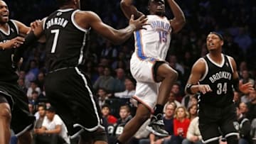 Jan 31, 2014; Brooklyn, NY, USA; Oklahoma City Thunder point guard Reggie Jackson (15) shoots the ball in front of Brooklyn Nets shooting guard Joe Johnson (7) and small forward Paul Pierce (34) in the first half at Barclays Center. Mandatory Credit: Noah K. Murray-USA TODAY Sports