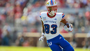 NORMAN, OK - OCTOBER 15: Wide receiver Quentin Skinner #83 of the Kansas Jayhawks takes a lateral pass for 20 yards to the 11-yard line against the Oklahoma Sooners in the first quarter at Gaylord Family Oklahoma Memorial Stadium on October 15, 2022 in Norman, Oklahoma. Oklahoma won 52-42. (Photo by Brian Bahr/Getty Images)