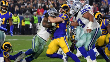 LOS ANGELES, CA - JANUARY 12: Bryce Hager #54 of the Los Angeles Rams tackles Ezekiel Elliott #21 of the Dallas Cowboys in the fourth quarter near the goal line in the NFC Divisional Playoff game at Los Angeles Memorial Coliseum on January 12, 2019 in Los Angeles, California. (Photo by Harry How/Getty Images)