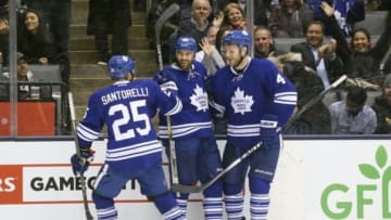 Feb 10, 2015; Toronto, Ontario, CAN; Toronto Maple Leafs center Daniel Winnik (26) celebrates his tying goal in the third period with center Mike Santorelli (25) and defenseman Cody Franson (4) against the New York Rangers at Air Canada Centre. The Rangers beat the Maple Leafs 5-4. Mandatory Credit: Tom Szczerbowski-USA TODAY Sports