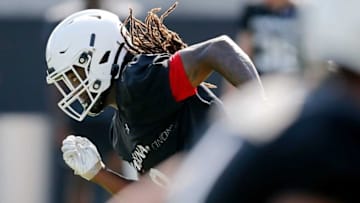 Bearcats safety Isiah Cox runs a drill during training camp. The Enquirer.