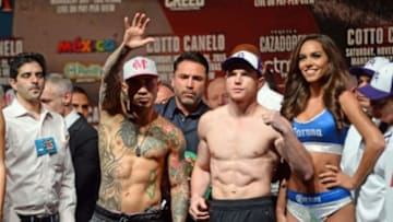 Nov 20, 2015; Las Vegas, NV, USA; Miguel Cotto (left) and Canelo Alvarez (right) pose for a photo during weigh-ins for their upcoming WBC middleweight title fight at Mandalay Bay. Mandatory Credit: Joe Camporeale-USA TODAY Sports