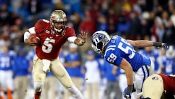 CHARLOTTE, NC - DECEMBER 07: Quarterback Jameis Winston #5 of the Florida State Seminoles is pressured by linebacker Kelby Brown #59 of the Duke Blue Devils during the ACC Championship game at Bank of America Stadium on December 7, 2013 in Charlotte, North Carolina. (Photo by Streeter Lecka/Getty Images)