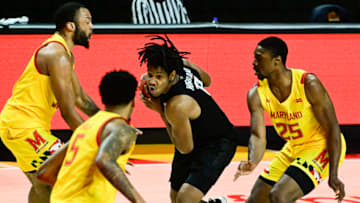 Feb 28, 2021; College Park, Maryland, USA; Michigan State Spartans guard A.J. Hoggard (11) makes a move to the basket in-between Maryland Terrapins forward Galin Smith (left) forward Jairus Hamilton (25) and guard Eric Ayala (5) during the first half at Xfinity Center. Mandatory Credit: Tommy Gilligan-USA TODAY Sports