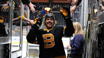 BOSTON, MA - DECEMBER 5: David Pastrnak #88 of the Boston Bruins high fives fans after warms ups before the game against the Chicago Blackhawks at the TD Garden on December 5, 2019 in Boston, Massachusetts. (Photo by Steve Babineau/NHLI via Getty Images)