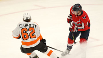 WASHINGTON, DC - MAY 07: Nicolas Aube-Kubel #62 of the Philadelphia Flyers and Nicklas Backstrom #19 of the Washington Capitals go after the puck in the first period at Capital One Arena on May 07, 2021 in Washington, DC. (Photo by Rob Carr/Getty Images)