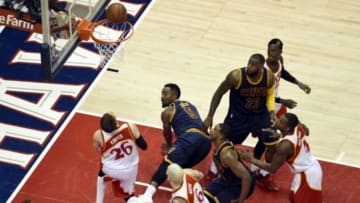 May 22, 2015; Atlanta, GA, USA; Cleveland Cavaliers guard J.R. Smith (5) falls to the ground as he shoots against Atlanta Hawks guard Kyle Korver (26) during the first half in game two of the Eastern Conference Finals of the NBA Playoffs at Philips Arena. Mandatory Credit: Dale Zanine-USA TODAY Sports