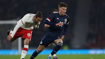 GLASGOW, SCOTLAND - MARCH 24: Nathan patterson of Scotland out paces Grzegorz Krychowiak of Poland during the international friendly match between Scotland and Poland at Hampden Park on March 24, 2022 in Glasgow, Scotland. (Photo by Ian MacNicol/Getty Images)