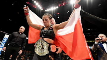 NEW YORK, NY - NOVEMBER 12: Joanna Jedrzejczyk of Poland is awarded the belt after her unanimous decision victory in their women's strawweight championship bout against Karolina Kowalkiewicz of Poland during the UFC 205 event at Madison Square Garden on November 12, 2016 in New York City. (Photo by Jeff Bottari/Zuffa LLC/Zuffa LLC via Getty Images)